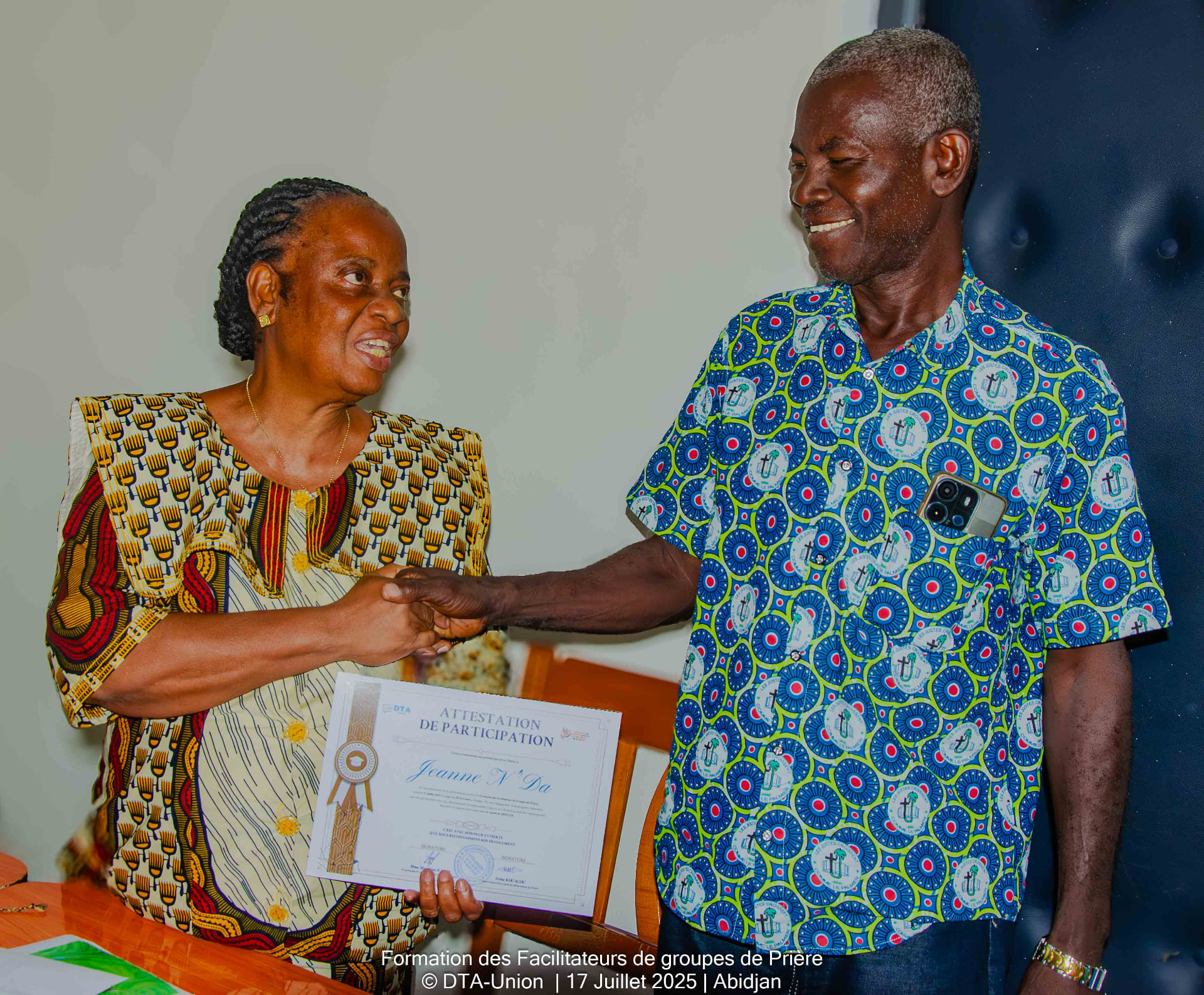 Jeanne N'Da recevant son attestation de participation des mains d'une responsable de DTA-Union